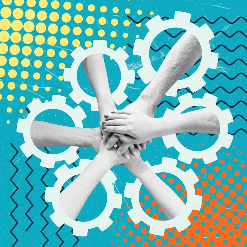 Several hands join in a circle, symbolizing teamwork and cooperation. Gears in the background represent the idea of working together in a creative setting.