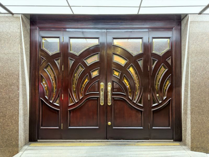 Elegant custom wooden door with intricate craftsmanship and rich finish.