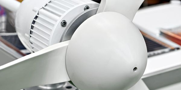 Close-up of a white industrial fan blade and motor.