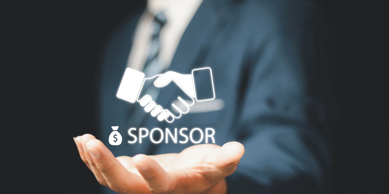 Businessman holding virtual sponsor handshake symbol.
