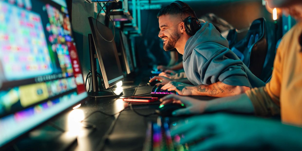 Man enjoying gaming session at computer setup.
