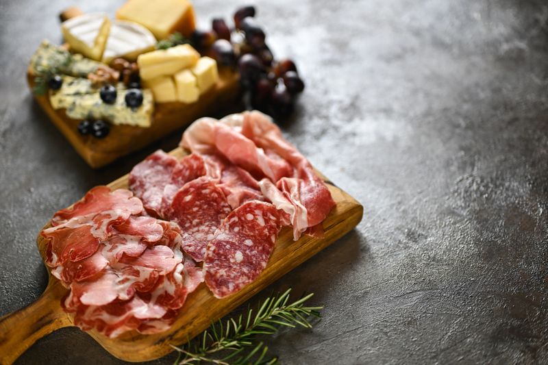 Assorted cured meats and cheese platter serving as a gourmet appetizer