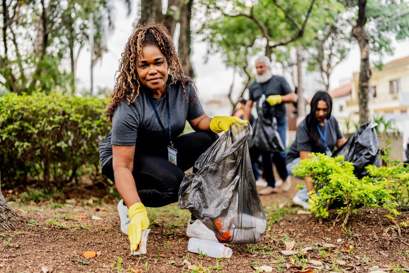 Portrait of volunteer collecting garbage outdoors