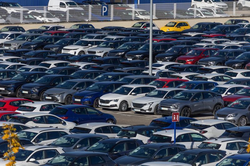 Madrid. Spain. Rows of new cars from multiple brands parked tightly in a large outdoor lot, inventory ready for distribution and sale