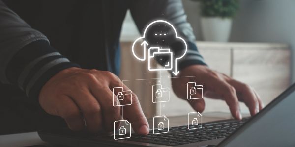 Person accessing secured cloud data on laptop.