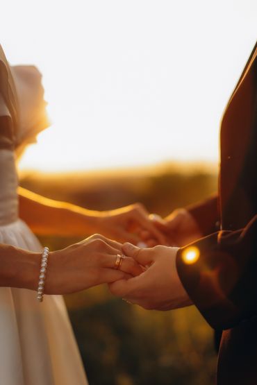 Couple embracing intimately in elegant attire.