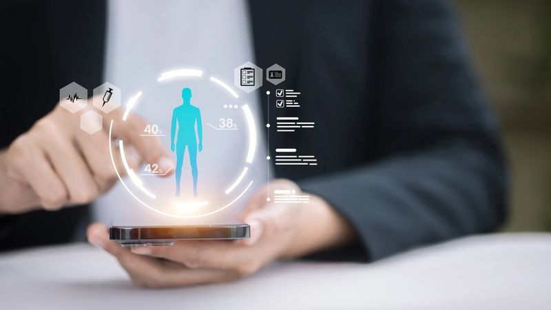 Adult professional uses a smartphone health app with holographic body dashboard, showing vitals and medical icons, representing digital records, remote monitoring, telemedicine and patient privacy.