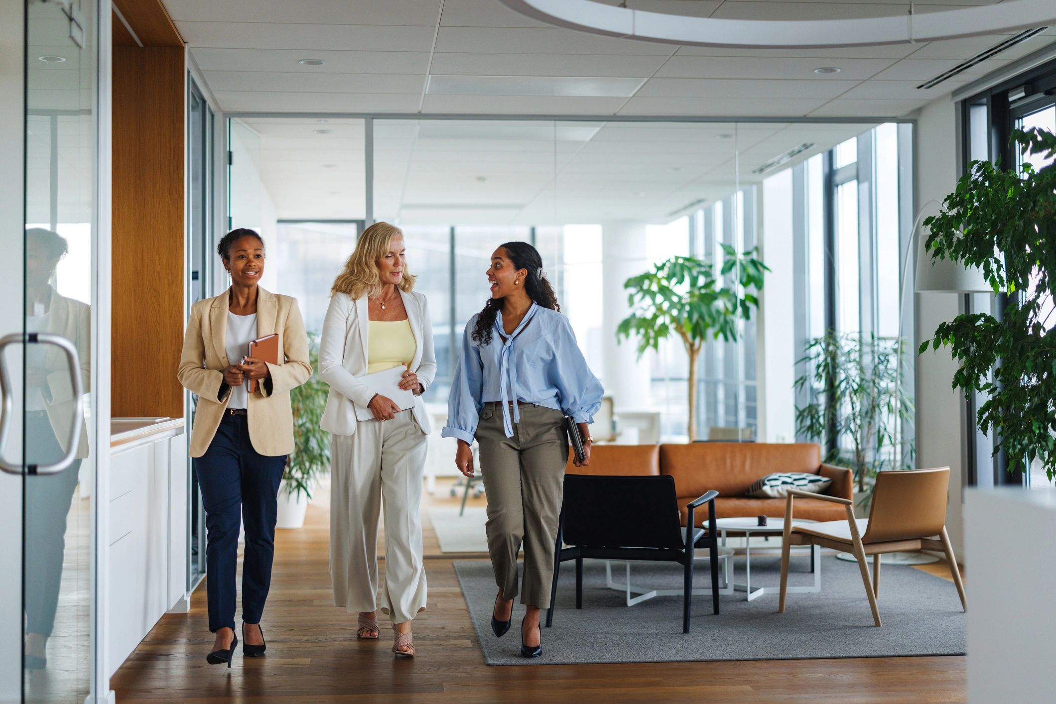 three women walking in an office together 