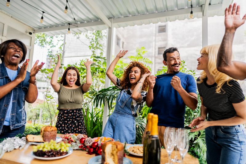 Friends or coworkers sharing joyful moment during rooftop party