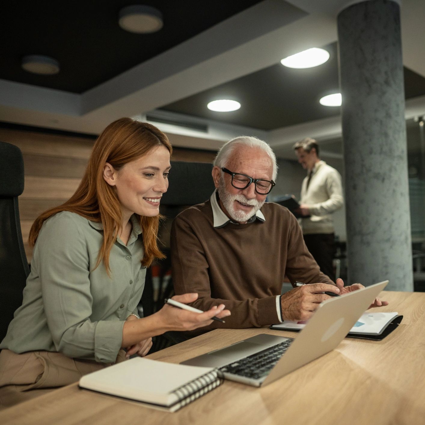Colleagues discussing work in an office.