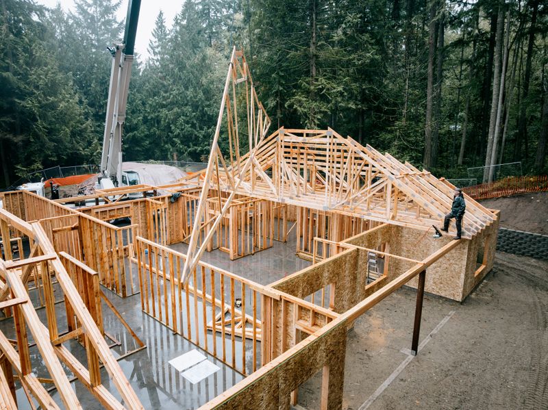 Construction workers building a structure on a job site