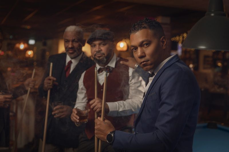 Small group of luxury black men friends enjoying downtime at a pool hall in the Netherlands