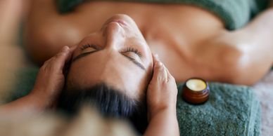 Woman receiving a relaxing head massage.