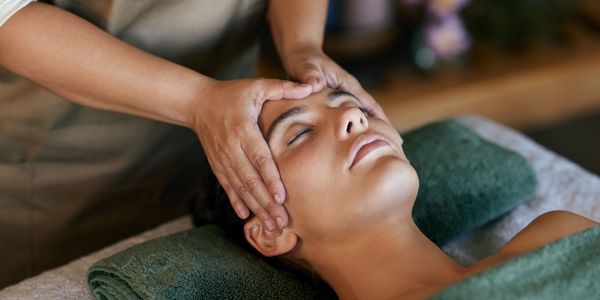 Person receiving a relaxing facial massage.