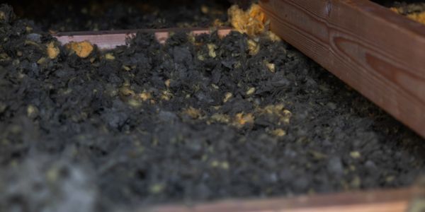 Close-up of insulation material in a wooden frame.