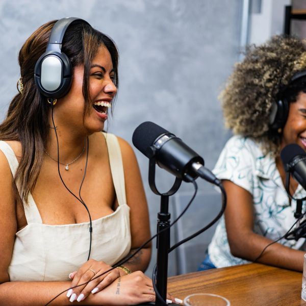 Two women enjoying a lively podcast recording session.