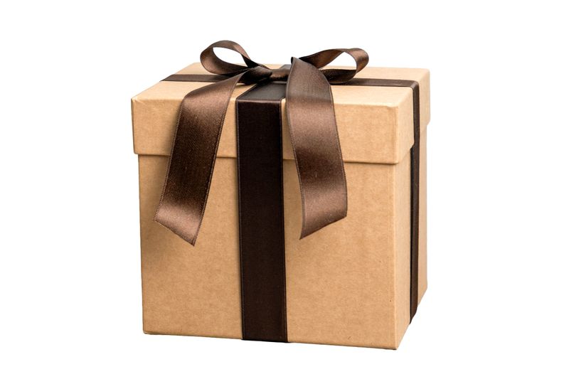Elegant brown gift box with satin ribbon bow isolated on white background, luxury present packaging for holidays, birthdays, weddings, or celebrations, minimal eco friendly craft paper design