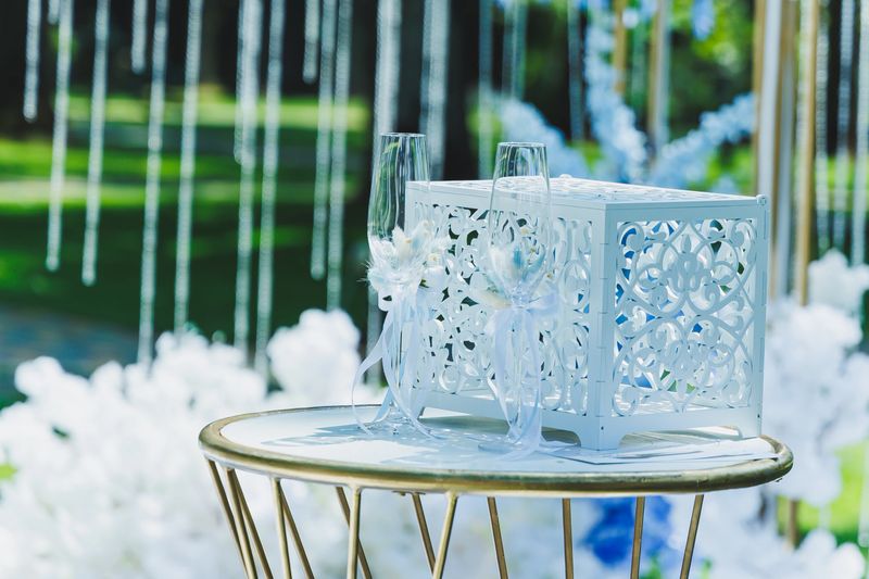 An exquisite and elegant setup for a beautiful wedding featuring toasting glasses and lovely floral decorations