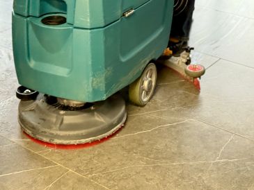 Floor cleaning machine polishing tile.