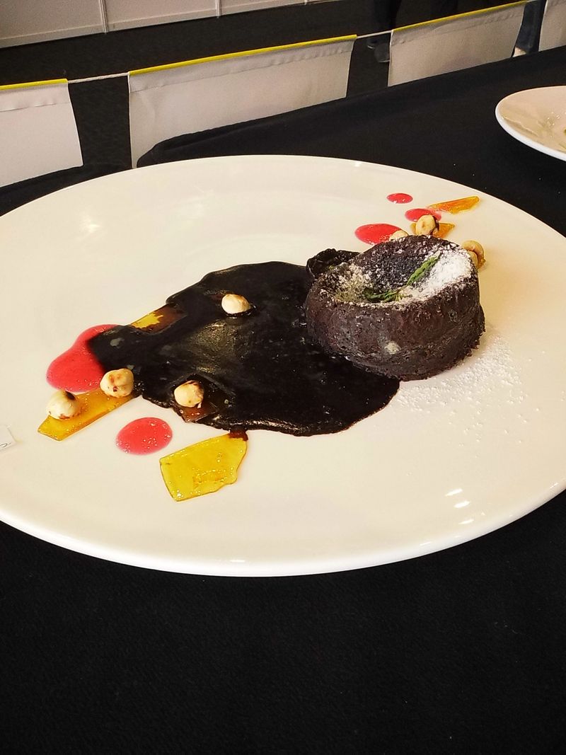 Sabah Hospitals Fiesta, 21–23 November 2025, SICC, Kota Kinabalu, Sabah.  A plated dessert featuring a glossy chocolate dome, accented with colorful sauce drizzles. The presentation reflects high-end pastry artistry, combining texture, temperature, and visual flair.