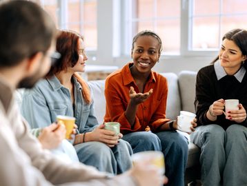 Group of friends chatting over coffee.