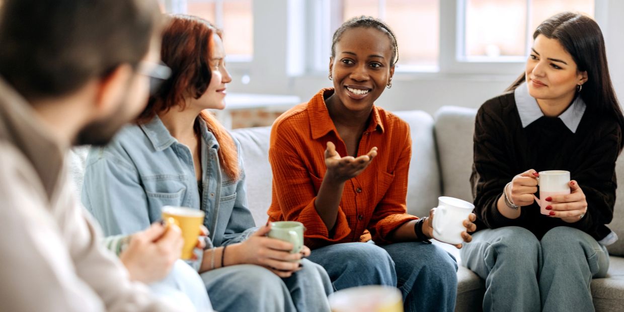 Group of friends chatting and drinking coffee.