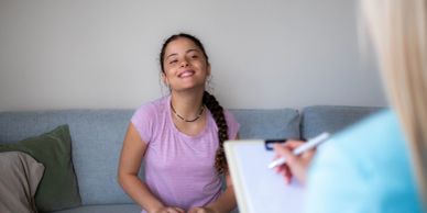 Young woman smiling during a therapy session.