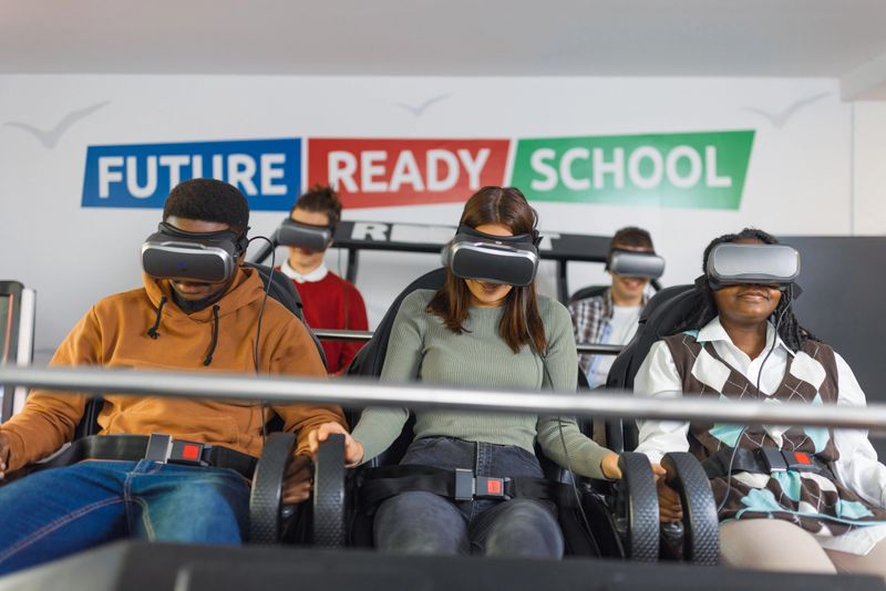 Group of diverse students engaged in virtual reality experience in a classroom designed for innovative learning.