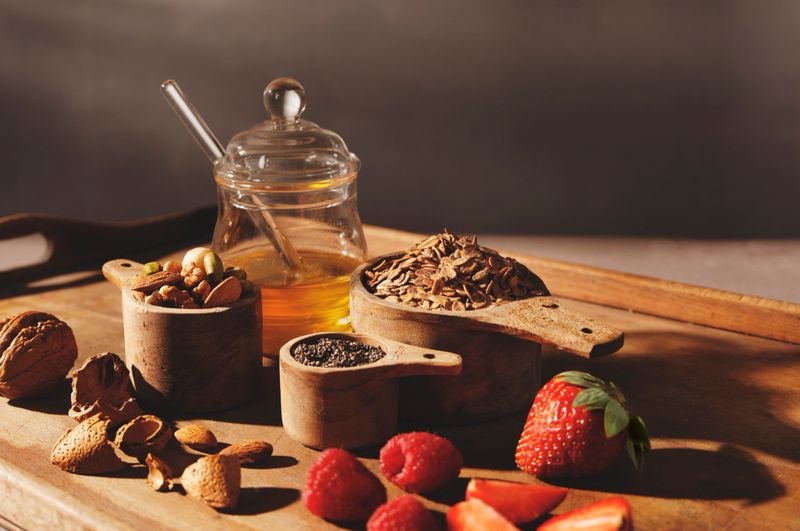Granola ingredients with honey and berry fruits