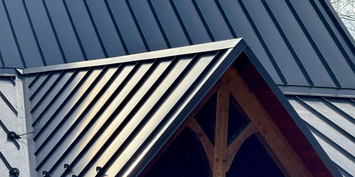 Metal roof with triangular wooden frame.