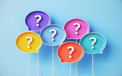 Colorful speech bubbles with question marks on sticks.