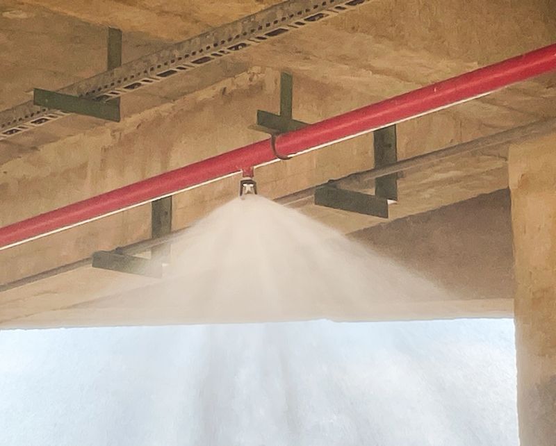 A mist suppression system in action protecting a commercial property from fire hazards.