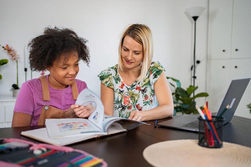 Mother and daughter studying and doing homework, enjoying diverse learning at home