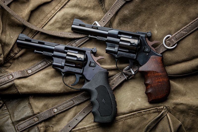 Pair of classic black revolvers on canvas background