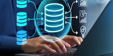 Person typing on laptop with digital data storage graphics overlay.