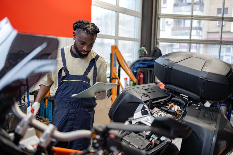 Man is working on a custom made motorbike