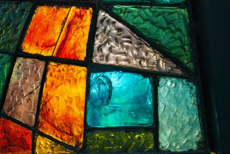 Simple stained glass windows of different colors in Tbilisi, grouped together