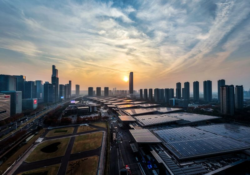 Solar panels on the rooftops of the city's financial district at dusk.