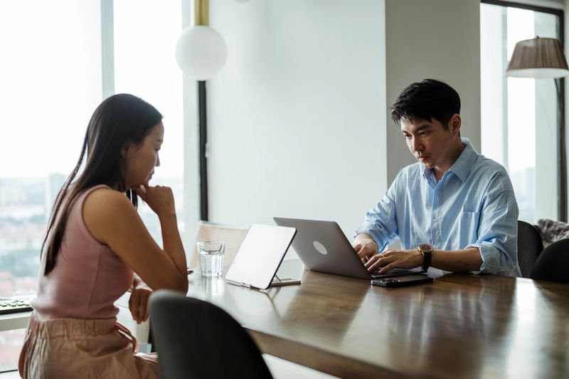 Professionals collaborating in a quiet indoor setting, reviewing information and working efficiently.