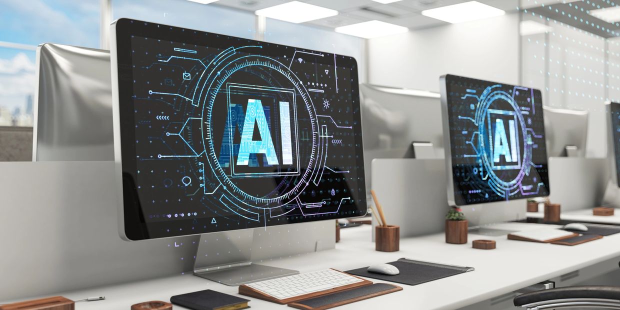 Modern office with AI-themed computer screens.