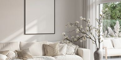 Bright modern living room with white sofa and decorative cushions.