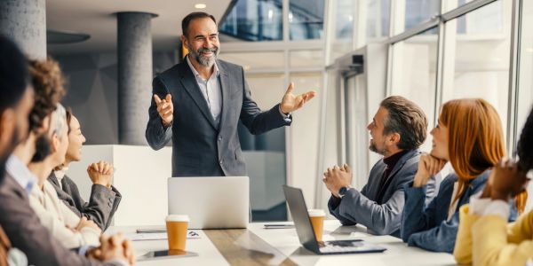 Man giving a presentation to colleagues in a modern office.