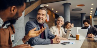 Colleagues sharing a joyful moment during a meeting.