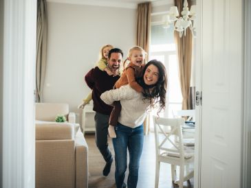 Happy family playing indoors together.