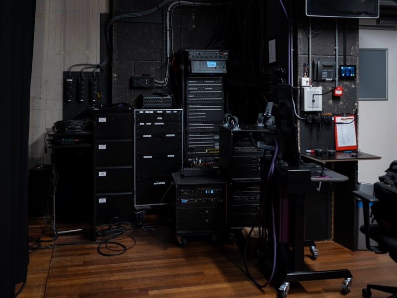 Server-style rack system with professional audio and video production equipment in studio environment
