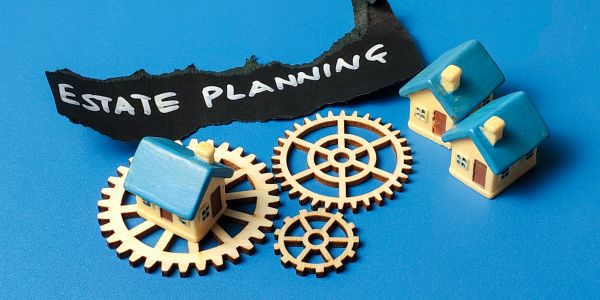 Miniature houses and gears with estate planning text.