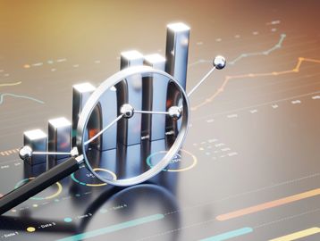 Magnifying glass highlighting a rising bar graph and data points.