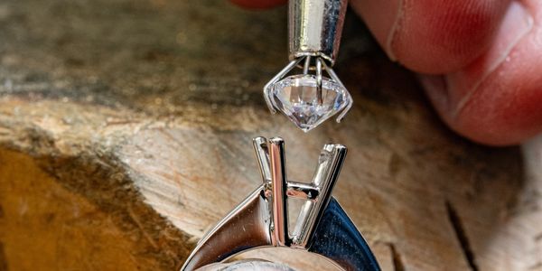 A diamond being set into a ring.