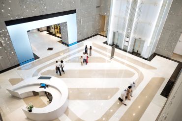 Modern spacious lobby with people walking.