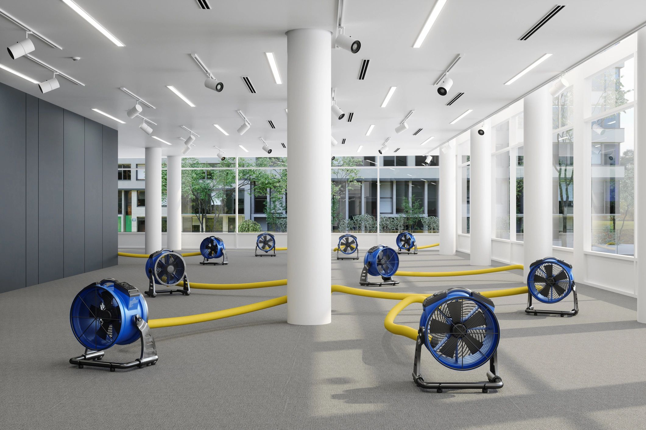 Room with large fans and yellow ducts in a modern building.